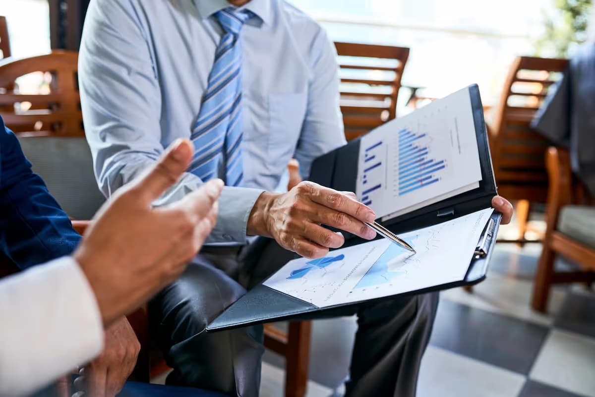 Business professionals reviewing compliance documents