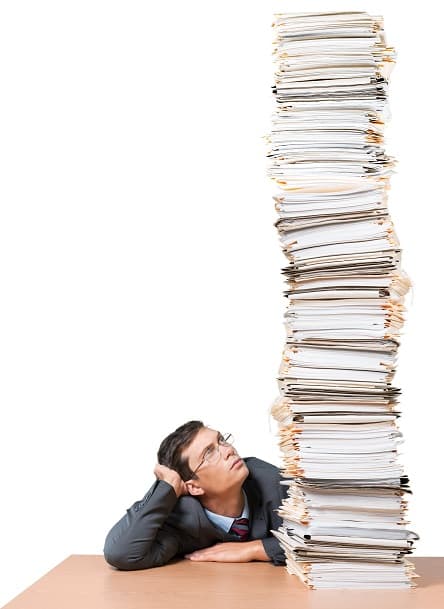 Person overwhelmed by paperwork
